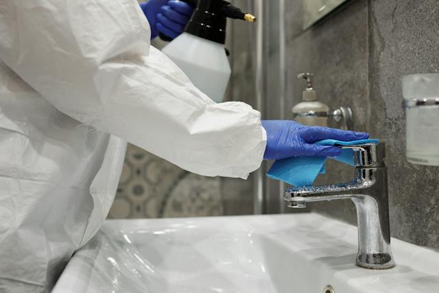 a-person-cleaning-faucet
